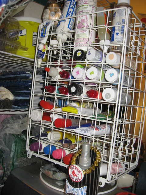 Paint Storage rack #12 with adhesives and paint on top of Roll top desk #4